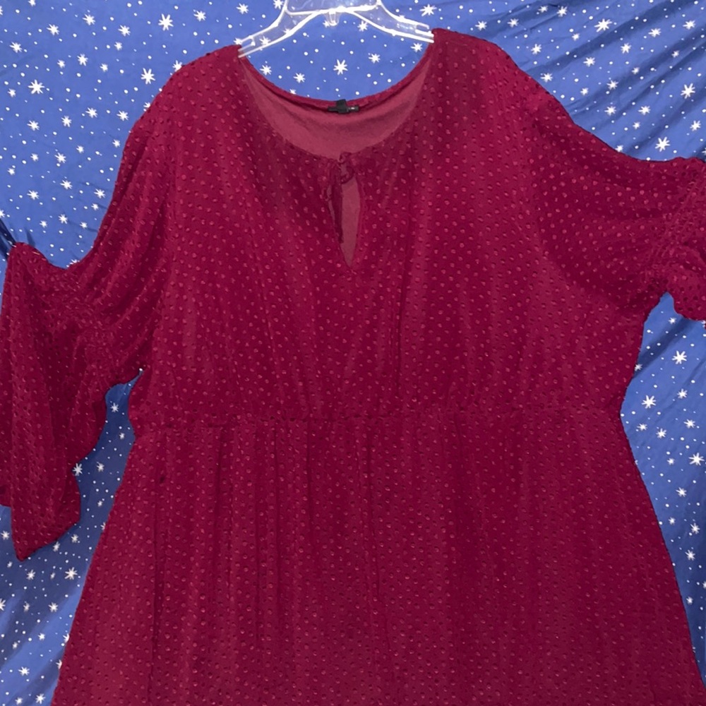 Burgundy dress with bell sleeves.